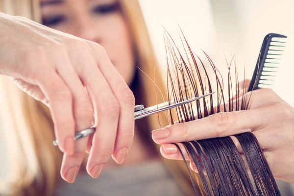 woman cutting hair ends getting perfect lob haircut viviscal hair blog