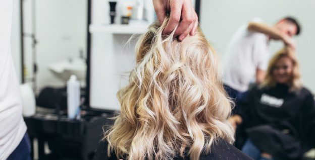 blonde curly woman back haircut salon getting perfect lob hairstyle viviscal hair blog