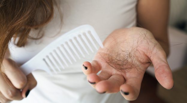 Healthy concept. Woman hand holding damaged long hair with Oil Hair Treatment. viviscal blog