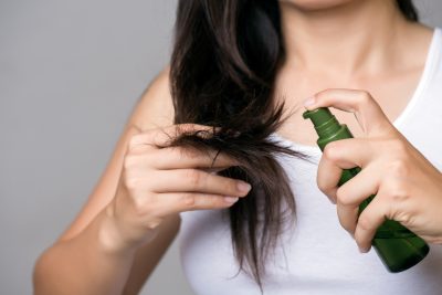 Healthy concept. Woman hand holding damaged long hair with Oil Hair Treatment. Viviscal blog